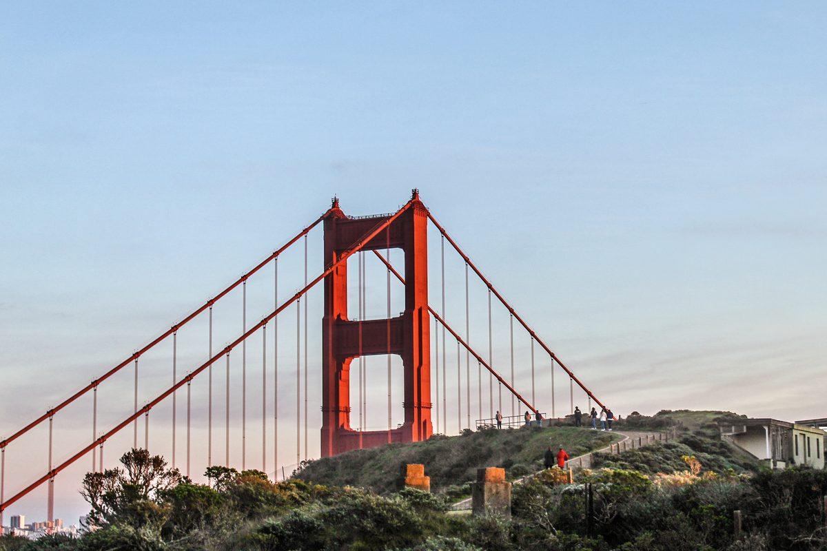 The Golden Gate Bridge in soft evening light, with the hills and city behind it