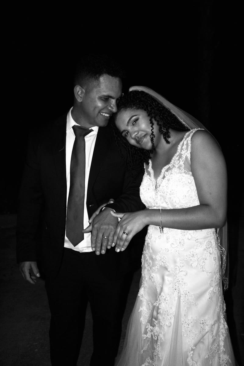 Black-and-white photo of a bride and groom embracing