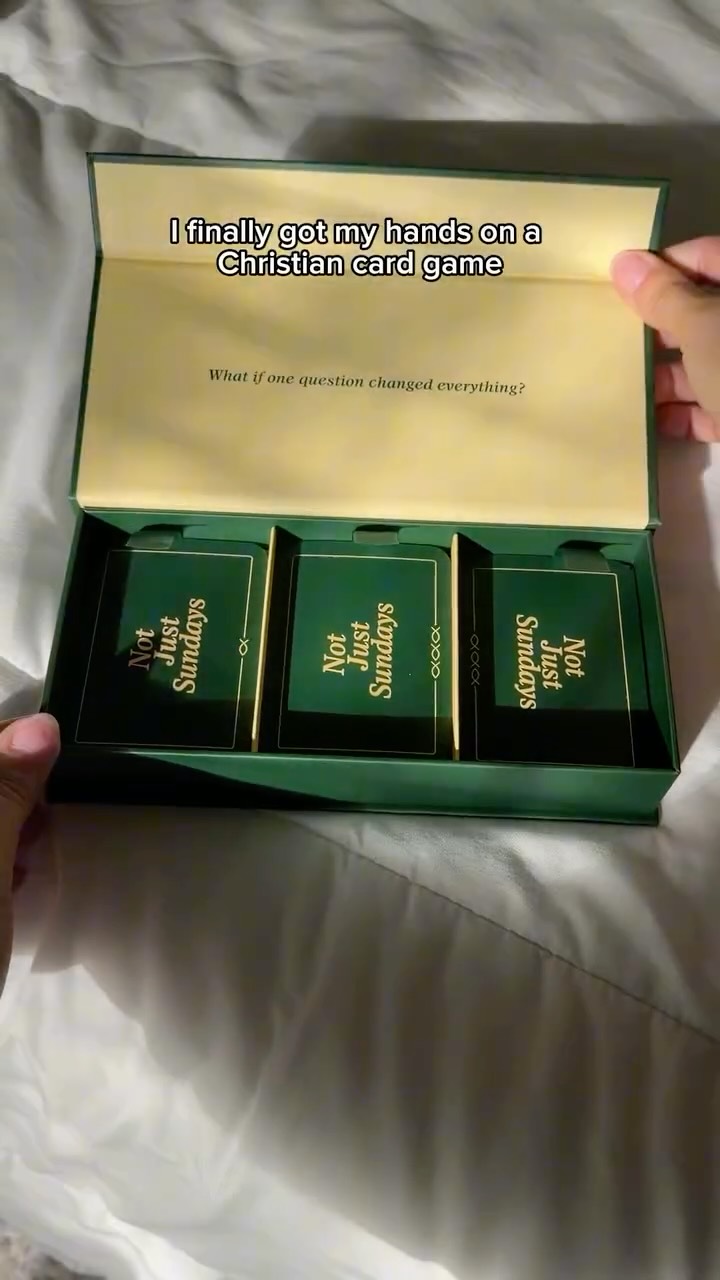Not Just Sundays card game box opened on a bed, with the text 'I finally got my hands on a Christian card game'