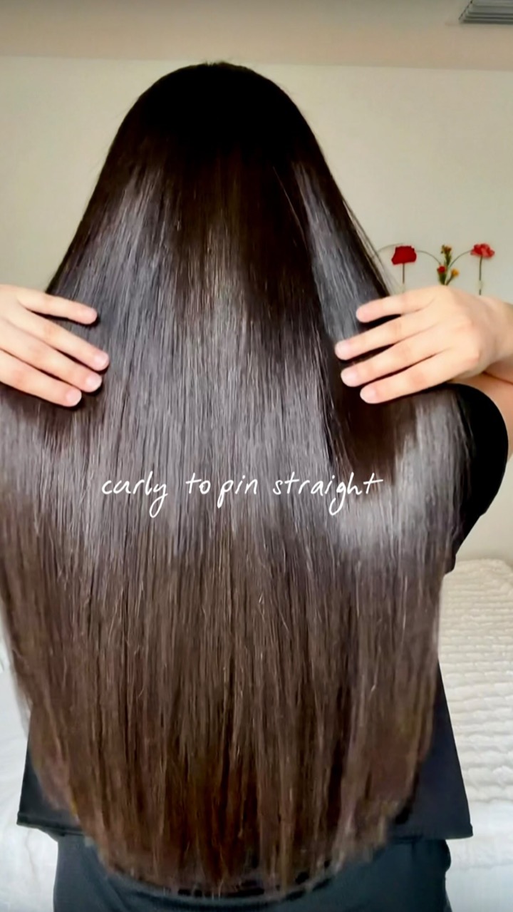 Back view of long, smooth, dark hair with the text 'curly to pin straight'